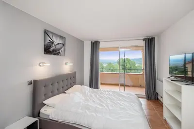 a bedroom with a bed and a large window at Village Pont Royal en Provence - maeva Home - Appartement moderne climatisé 4 pièces 8 personnes - Sélection - super Home MAE-8568 in Mallemort