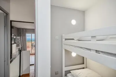 a bedroom with a bunk bed and a mirror at Village Pont Royal en Provence - maeva Home - Appartement moderne climatisé 4 pièces 8 personnes - Sélection - super Home MAE-8568 in Mallemort