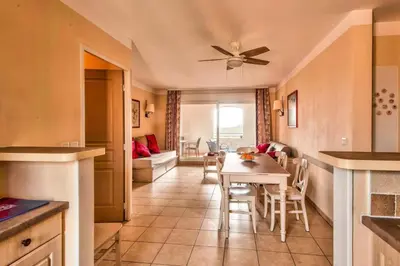 a kitchen and dining room with a table and chairs at Les Coteaux de Pont Royal en Provence - maeva Home - Appartement 3 Pièces 6 Personnes - Sélection MAE-5989 in Mallemort