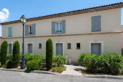 a building with a street light in front of it at Les Coteaux de Pont Royal en Provence - maeva Home - Maison 3 Pièces 6 Personnes - Sélection MAE-7944 in Mallemort