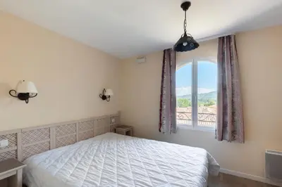 a bedroom with a bed and a window at Les Coteaux de Pont Royal en Provence - maeva Home - Maison 3 Pièces 6 Personnes - Sélection MAE-7944 in Mallemort