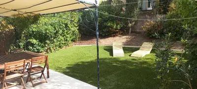 a patio with a table and chairs and an umbrella at Village Pont Royal en Provence - maeva Home - Maison de charme climatisée 4 pièces 8 personnes - Sélection - super Home MAE-7694 in Mallemort