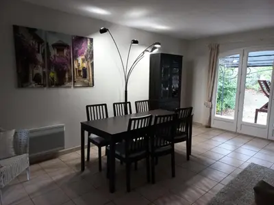 a dining room with a table and chairs and a lamp at Village Pont Royal en Provence - maeva Home - Maison de charme climatisée 4 pièces 8 personnes - Sélection - super Home MAE-7694 in Mallemort