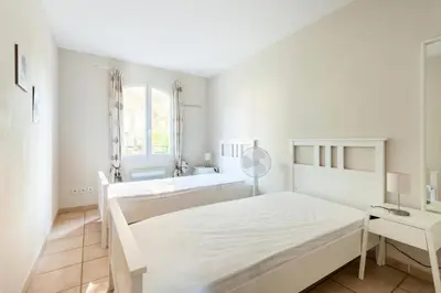 a white bedroom with a bed and a sink at Village Pont Royal en Provence - maeva Home - Maison de charme climatisée 4 pièces 8 personnes - Sélection - super Home MAE-7694 in Mallemort