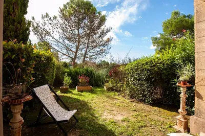 a garden with a chair and some plants at Village Pont Royal en Provence - maeva Home - Appartement 2 Pièces 6 Personnes - Sélection MAE-9534 in Mallemort