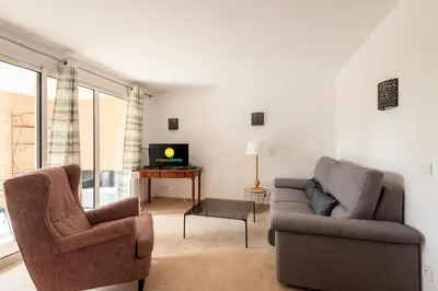 a living room with a couch and a chair and a tv at Village Pont Royal en Provence - maeva Home - Appartement 2 Pièces 6 Personnes - Sélection MAE-9534 in Mallemort