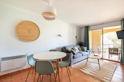 a living room with a couch and a table and chairs at Résidence Hôtel du Golf de Pont Royal - maeva Home - Appartement climatisé ravissant 2 pièces 4 personnes - Prestige - super Home MAE-3104 in Mallemort