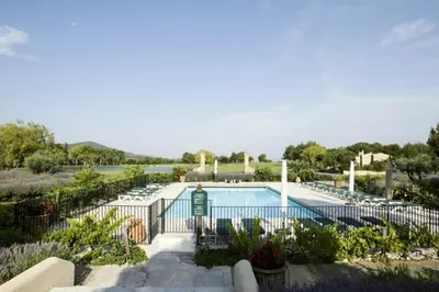 a swimming pool in a resort with chairs at Résidence Hôtel du Golf de Pont Royal - maeva Home - Appartement climatisé ravissant 2 pièces 4 personnes - Prestige - super Home MAE-3104 in Mallemort
