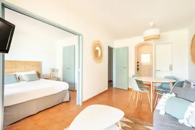 a bedroom with a bed and a table and a couch at Résidence Hôtel du Golf de Pont Royal - maeva Home - Appartement climatisé ravissant 2 pièces 4 personnes - Prestige - super Home MAE-3104 in Mallemort