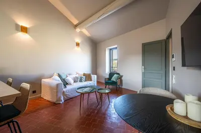 a living room with a couch and a table at La Terrasse d'Eygalières in Eygalières
