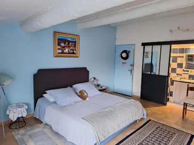 a teddy bear laying on a bed in a bedroom at Clos des Hérissons - Chambres d'Hôte - Piscine & jardin in Lauris