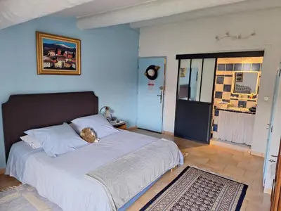 a bedroom with a bed with a teddy bear on it at Clos des Hérissons - Chambres d'Hôte - Piscine & jardin in Lauris