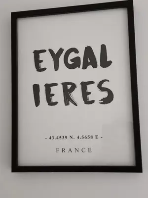 a framed picture of a sign with the words legal fees at Le Mas Joséphine in Saint-Rémy-de-Provence