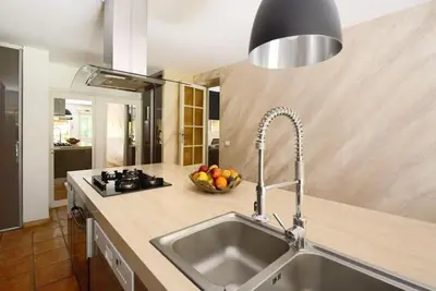 a kitchen with a sink and a bowl of fruit at Maison de Charme au Pays de Cézanne in Aix-en-Provence