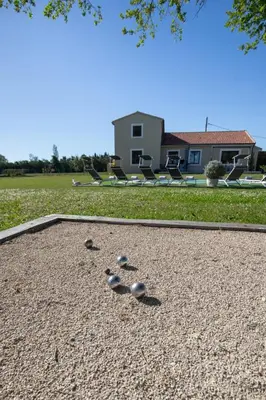 a group of rocks sitting on the ground at Maison contemporaine - grand jardin et piscine privée in LʼIsle-sur-la-Sorgue