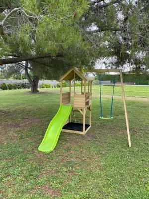 a playground with a green slide in a park at Maison contemporaine - grand jardin et piscine privée in LʼIsle-sur-la-Sorgue