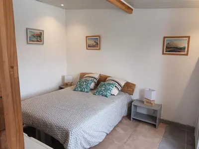 a bedroom with a bed with two pillows on it at Chalet banane devant piscine, a 6km du festival de piano de la roque d'anthéron in Rognes