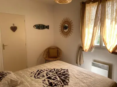 a bedroom with a bed and a chair and a mirror at Une Oasis au Pays de Cézanne in Aix-en-Provence