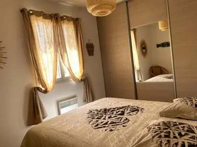 a bedroom with a large mirror and a bed at Une Oasis au Pays de Cézanne in Aix-en-Provence