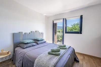 a bedroom with a large bed and a window at campdebaseventoux, vue sur le ventoux insolite in Bédoin