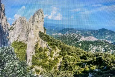 a mountain with trees and mountains in the background at campdebaseventoux, vue sur le ventoux insolite in Bédoin