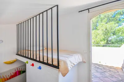 a bedroom with a crib and a window at Les Maisons de Pont Royal en Provence - maeva Home - Maison 3 pièces 6 personnes - Sélection MAE-2277 in Mallemort
