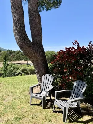 two white chairs sitting next to a tree at Les Maisons de Pont Royal en Provence - maeva Home - Maison 3 pièces 6 personnes - Sélection MAE-2277 in Mallemort