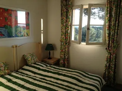 a bedroom with a bed and two windows at Les Maisons de Pont Royal en Provence - maeva Home - Maison 3 pièces 6 personnes - Sélection MAE-2277 in Mallemort