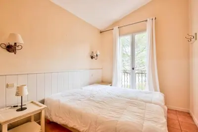 a bedroom with a white bed and a window at Les Maisons de Pont Royal en Provence - maeva Home - Maison 3 pièces 6 personnes climatisé - Sélection MAE-6421 in Mallemort