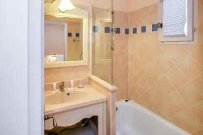 a bathroom with a sink and a tub and a mirror at Les Maisons de Pont Royal en Provence - maeva Home - Maison climatisée 3 pièces 6 personnes - Sélection MAE-6972 in Mallemort