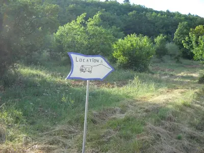 a blue and white sign in the middle of a field at Aurel inattendu in Aurel