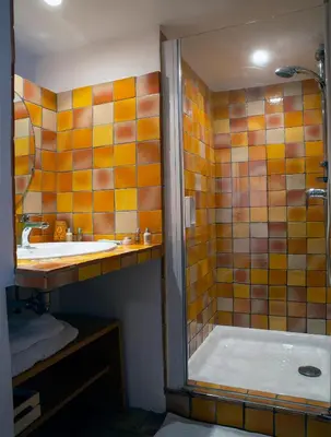 a bathroom with a tub and a sink and a shower at Le Clos des Amandiers in Simiane-la-Rotonde