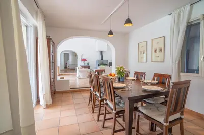 a dining room with a wooden table and chairs at Maison des lavandes in Saint-Cannat