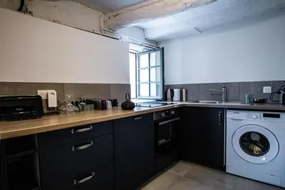 a kitchen with a sink and a washing machine at Maison en campagne avec vues panoramiques - close to a lake in La Tour-dʼAigues