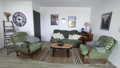a living room with two chairs and a couch and a table at Une escapade en Luberon in Bonnieux