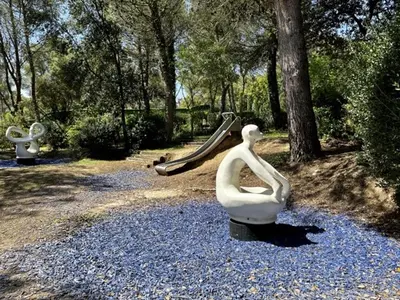 a sculpture of a woman sitting on a rock with a slide at Maison de Vacances en Provence avec Piscine, Golf à Proximité, Fibre et Linge Haut de Gamme - FR-1-658-9 in Mallemort