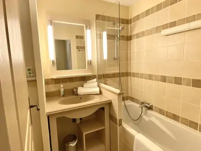 a bathroom with a sink and a mirror and a tub at Maison de Vacances en Provence avec Piscine, Golf à Proximité, Fibre et Linge Haut de Gamme - FR-1-658-9 in Mallemort