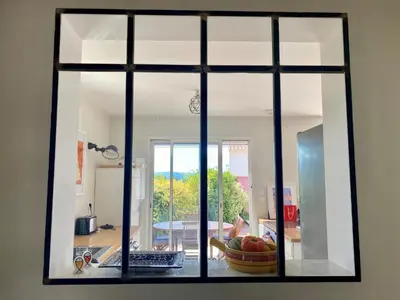 a view of a kitchen through a window at nice house with private pool - 6 persons in the center of the village of mérindol in the luberon in provence in Mérindol