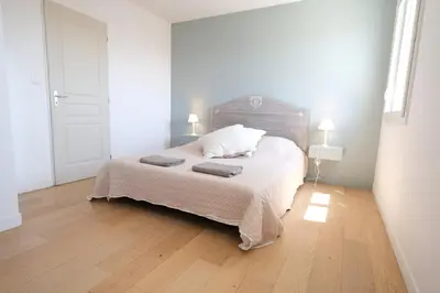 a bedroom with a bed with two pillows on it at nice house with private pool - 6 persons in the center of the village of mérindol in the luberon in provence in Mérindol