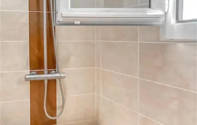 a shower in a bathroom with a window at 3 Bedroom Gorgeous Home In Gargas in Gargas