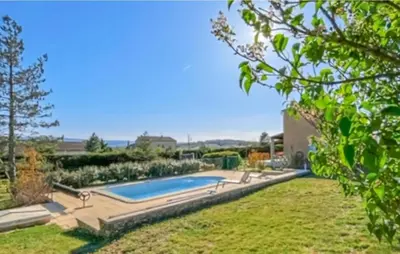 a swimming pool in the yard of a house at 3 Bedroom Gorgeous Home In Gargas in Gargas