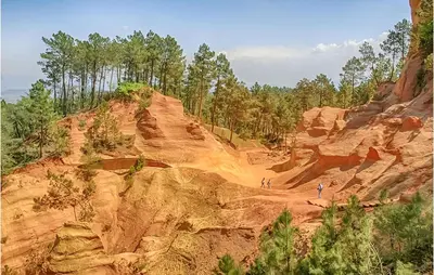 two people walking on a dirt hill with trees at 3 Bedroom Gorgeous Home In Gargas in Gargas