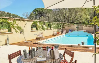 a patio with a table and a swimming pool at Gorgeous Home In Vernègues in Vernègues