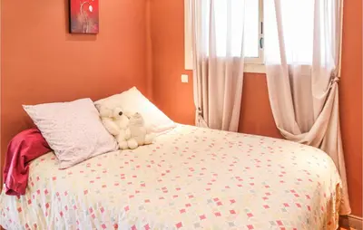 a teddy bear sitting on top of a bed at Gorgeous Home In Vernègues in Vernègues