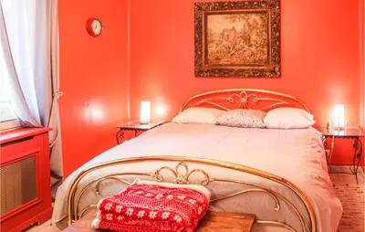 a red bedroom with a bed with a red wall at Gorgeous Home In Vernègues in Vernègues