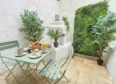 a table with a plate of food on a balcony at Le Petit Patio in Aix-en-Provence