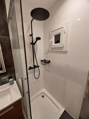a shower with a glass door next to a sink at Le Mistralet in Salon-de-Provence