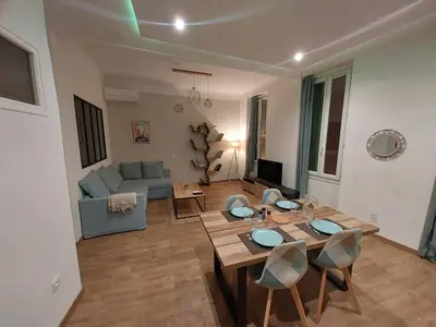 a living room with a table and a couch at Le Mistralet in Salon-de-Provence
