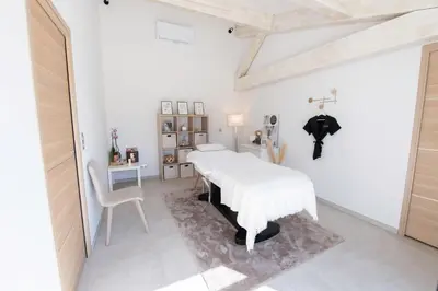a white bedroom with a white bed and a desk at Maison Réglisse du MAS LOU CAPY in Salon-de-Provence