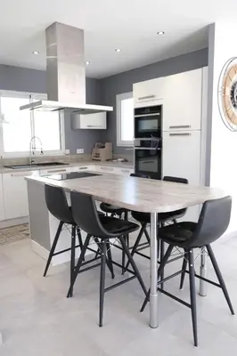a kitchen with a wooden table and chairs at charming villa with heated pool, 14 people, located in aureille, near les baux de provence, in the alpilles in Aureille